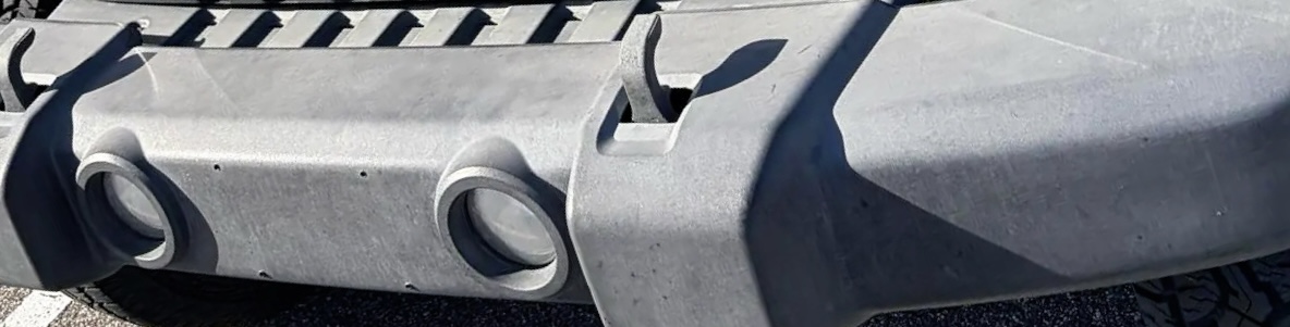 Faded gray Jeep bumper damaged by Florida sun